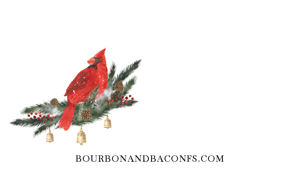 Decorative Christmas arrangement with a red cardinal bird on a white background, featuring the brand 'Bourbon and Bacons'.